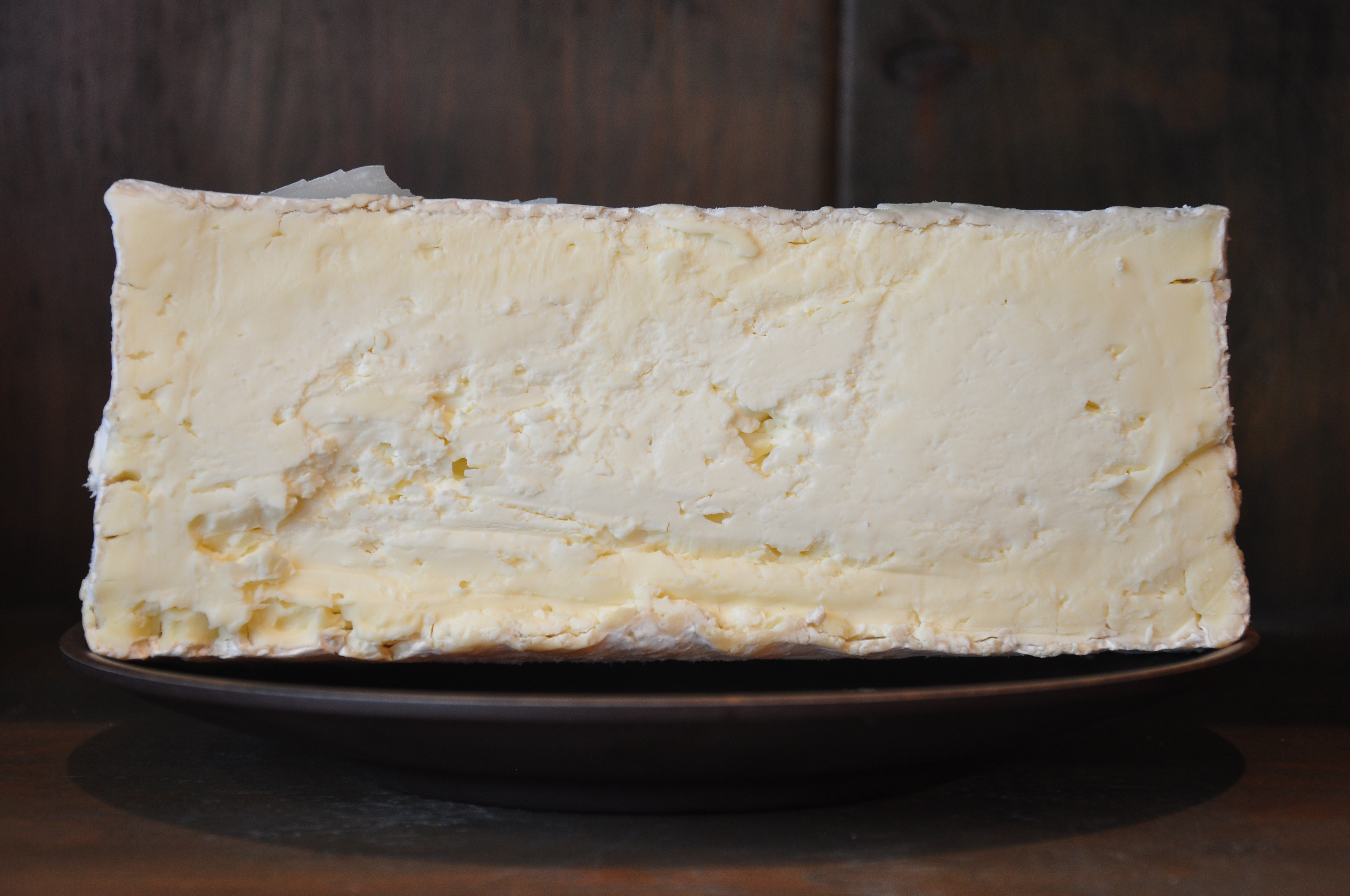 Round of St. Andre French triple-cream cheese with white bloomy rind